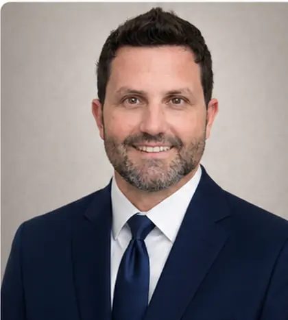 Matthew Ward in a navy suit and tie.