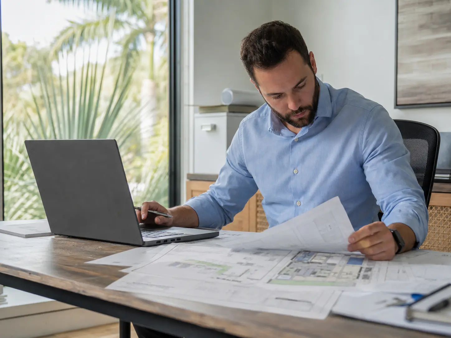 Professional engineer reviewing technical documents and a continuing-education plan.